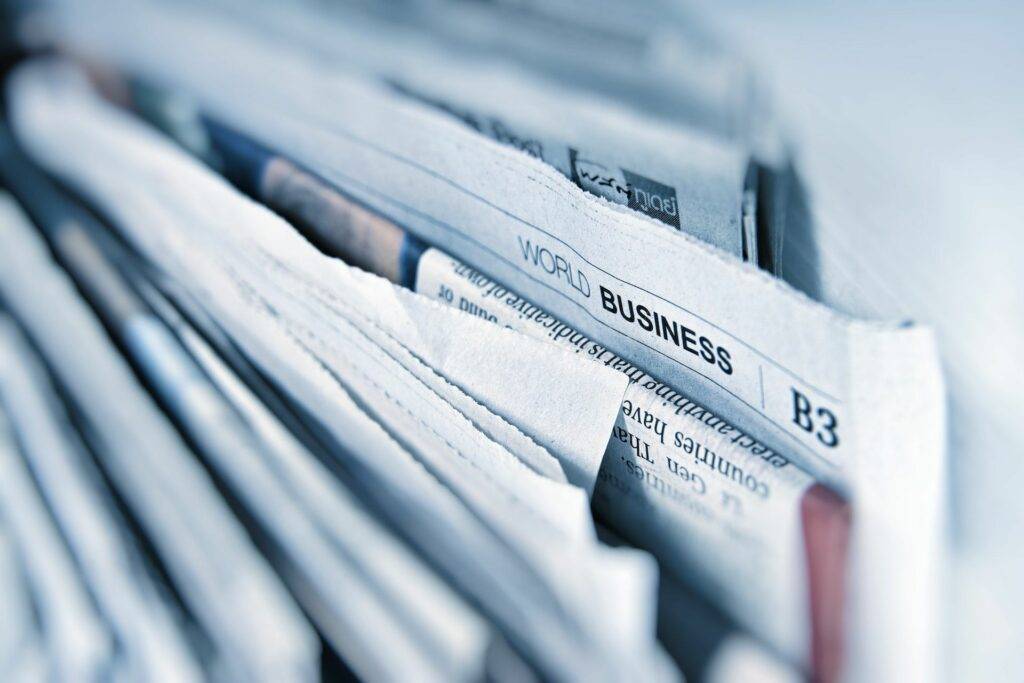 A close up of newspapers on a desk.
